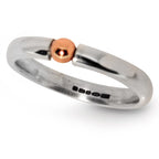 An angled perspective of The Solis Original ring, showcasing the sleek, contemporary profile and the subtle contrast between the silver and rose gold elements.