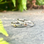 A contemporary lifestyle image of the Solis Original ring resting on a textured concrete surface, highlighting the contrast between the polished silver and the industrial backdrop.