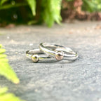 A contemporary lifestyle image of the Solis Original ring resting on a textured concrete surface, highlighting the contrast between the polished silver and the industrial backdrop.