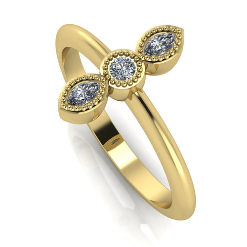 Angled perspective of an 18ct yellow gold trilogy ring with three diamonds featuring fine milgrain textured edges.