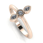 Angled perspective of an 18ct rose gold trilogy diamond ring with fine milgrain textured edges around the settings.