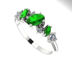 An angled perspective of the Atlantis Paradise ring highlighting the light interaction with the green tsavorite and diamonds.