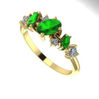 An angled view of the 18ct yellow gold ring highlighting the light interaction with the tsavorite and diamonds.