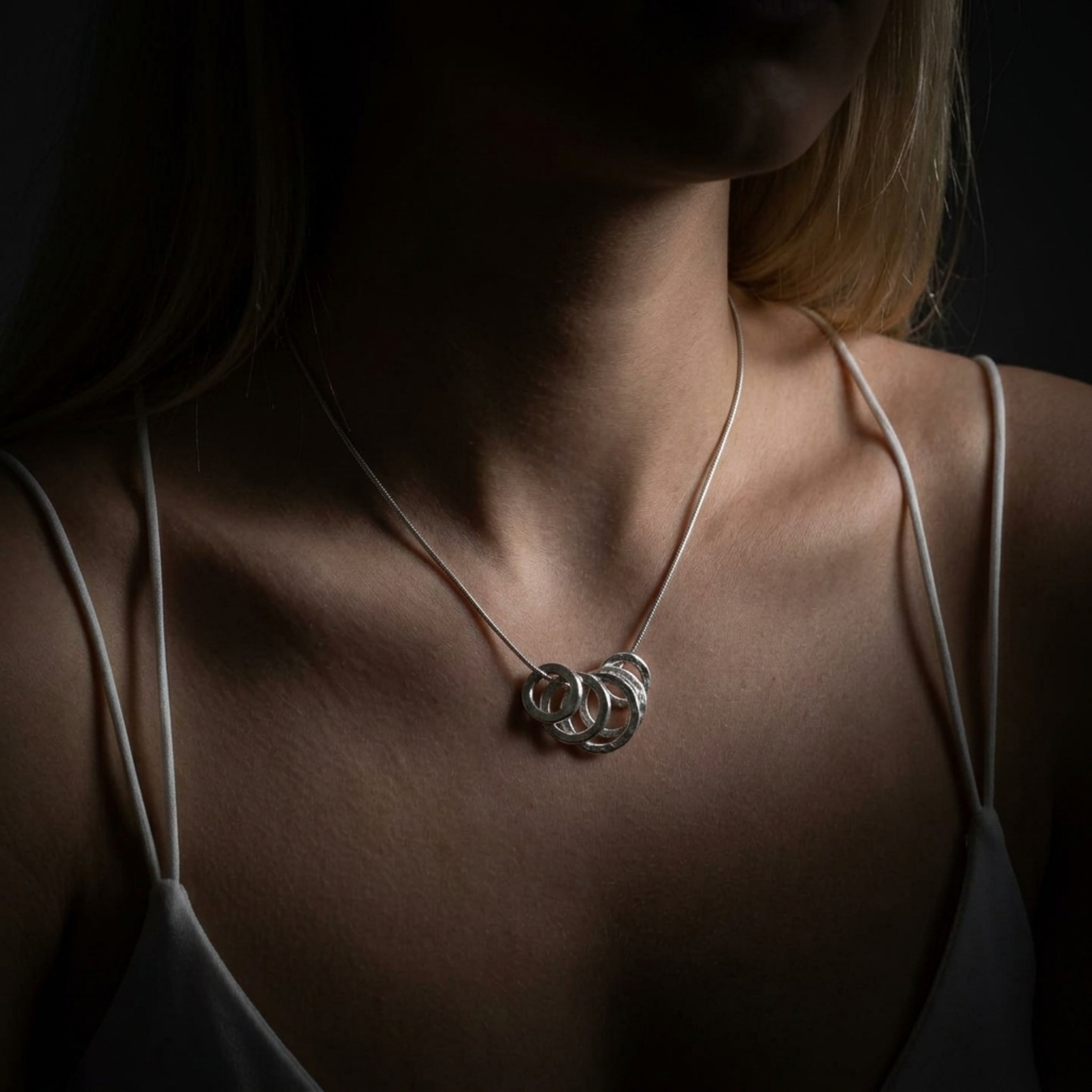 Scale view of the 5-link sterling silver Vanilla pendant demonstrating the length and statement scale of the design.