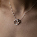 Close up front view of the Vanilla Links Tri-Pendant in sterling silver featuring three interlocking graduated concave discs.