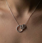 Close-up of the Vanilla Links Tri Pendant worn on a model, showing three graduated textured sterling silver circular links on a silver snake chain.
