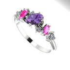 An angled view of the Atlantis Paradise ring highlighting the light-catching facets of the violet and pink sapphires.