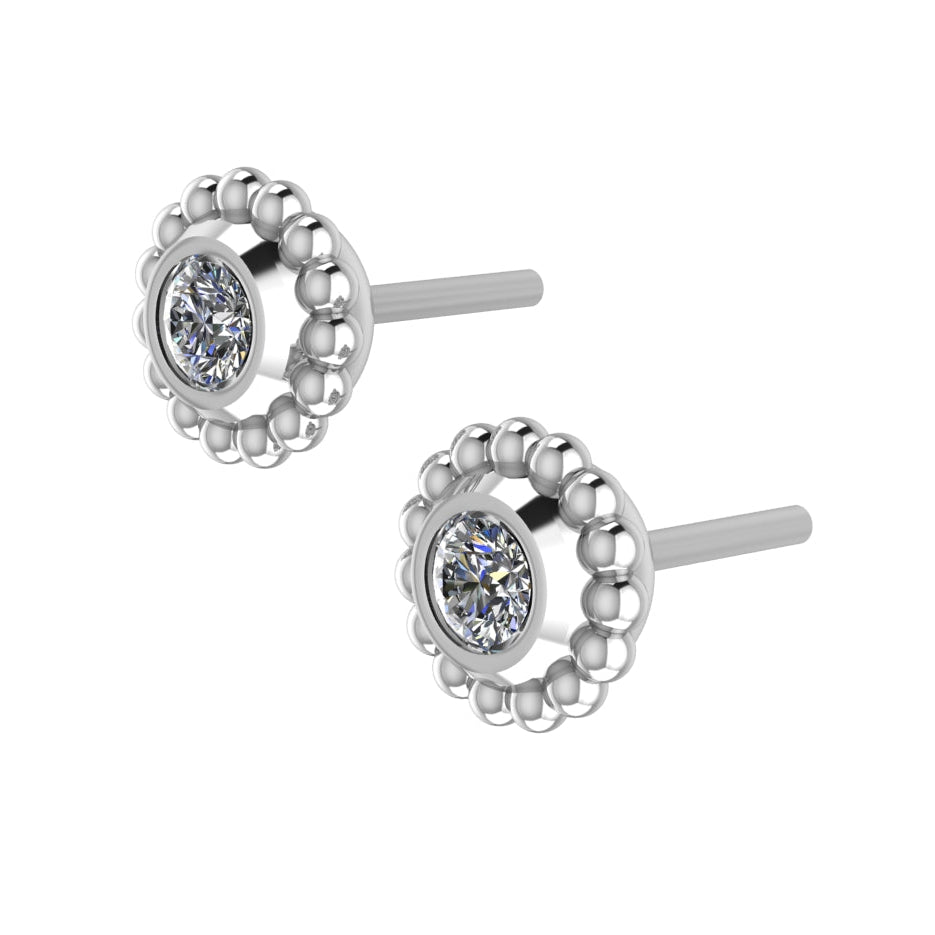 An angled perspective of the Silver Mini Alto earrings, highlighting the architectural silver mounting and the light-reflecting clarity of the white topaz stones.