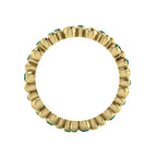Through-finger view of the 18ct yellow gold eternity ring, showcasing the smooth, polished interior under-gallery and the clean, secure gem settings.