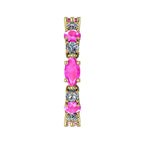 Macro shot of the alternating pink sapphire and diamond pattern on yellow gold.
