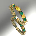 Eternity ring in 18ct yellow gold featuring alternating marquise-cut yellow sapphires and vibrant green emeralds.